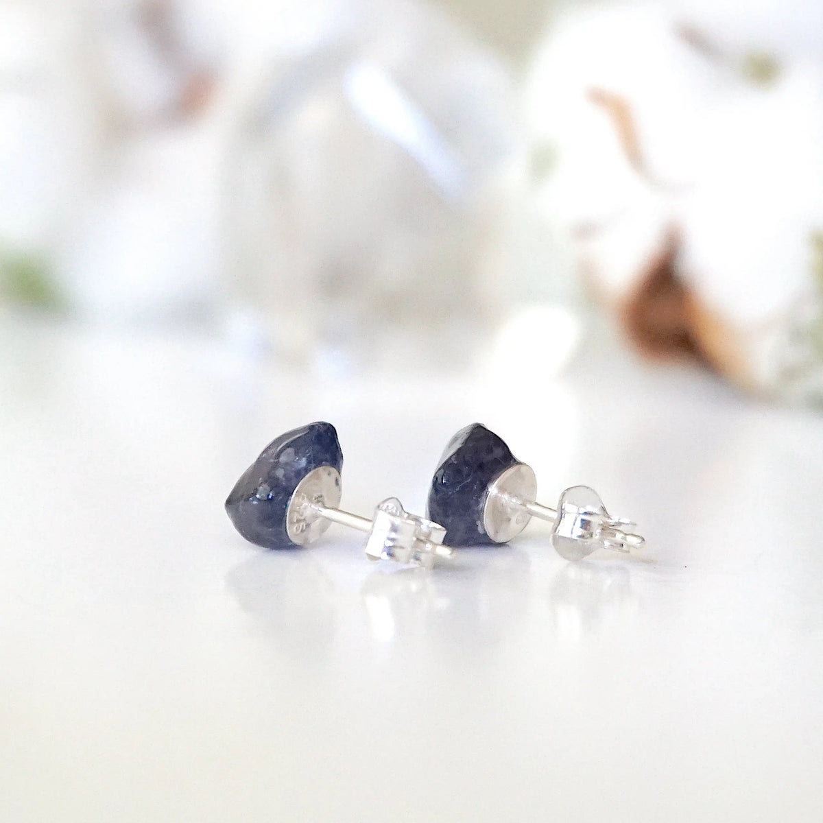Back view of raw sapphire stud earrings showing the 925 sterling silver posts and earring backs