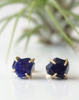 Front view of genuine raw sapphire stud earrings showing their natural blue colour and minimalist 14k gold vermeil prong settings