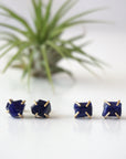 Two pairs of raw sapphire stud earrings showing natural variation in stone shape, size, and shade of blue — each pair is one of a kind