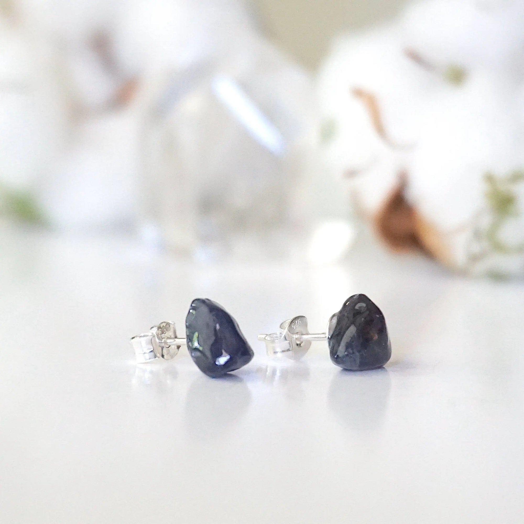 Right-angle detail of natural raw sapphire stud earrings showing the stone profile and 925 sterling silver posts