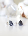 Right-angle detail of natural raw sapphire stud earrings showing the stone profile and 925 sterling silver posts