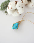 Raw turquoise necklace in 14k gold filled laying flat. Handcrafted December birthstone jewelry for women by Designs by Nature Gems.