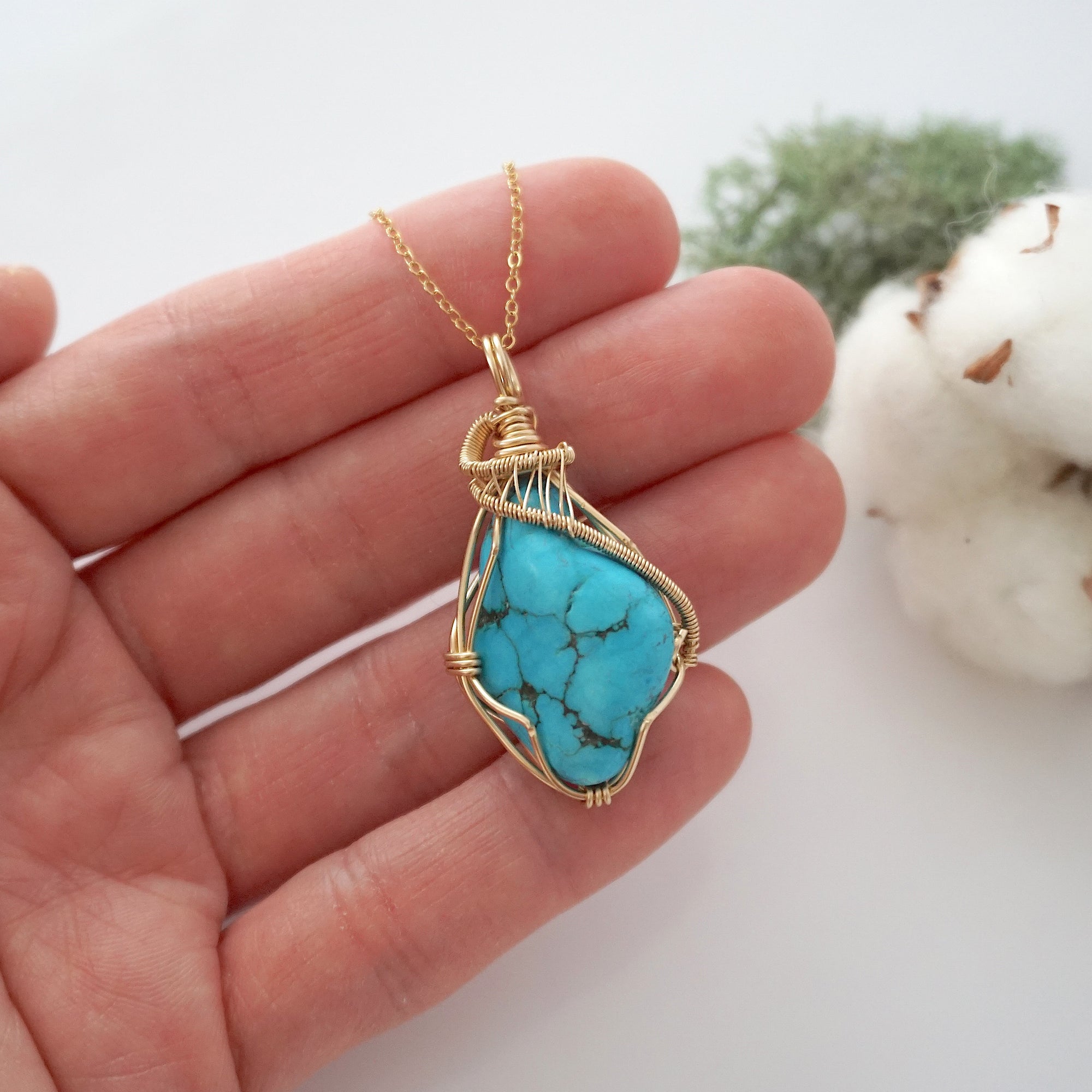 Raw turquoise necklace in 14k gold filled shown in hand for size reference. Artisan December birthstone pendant by Designs by Nature Gems.