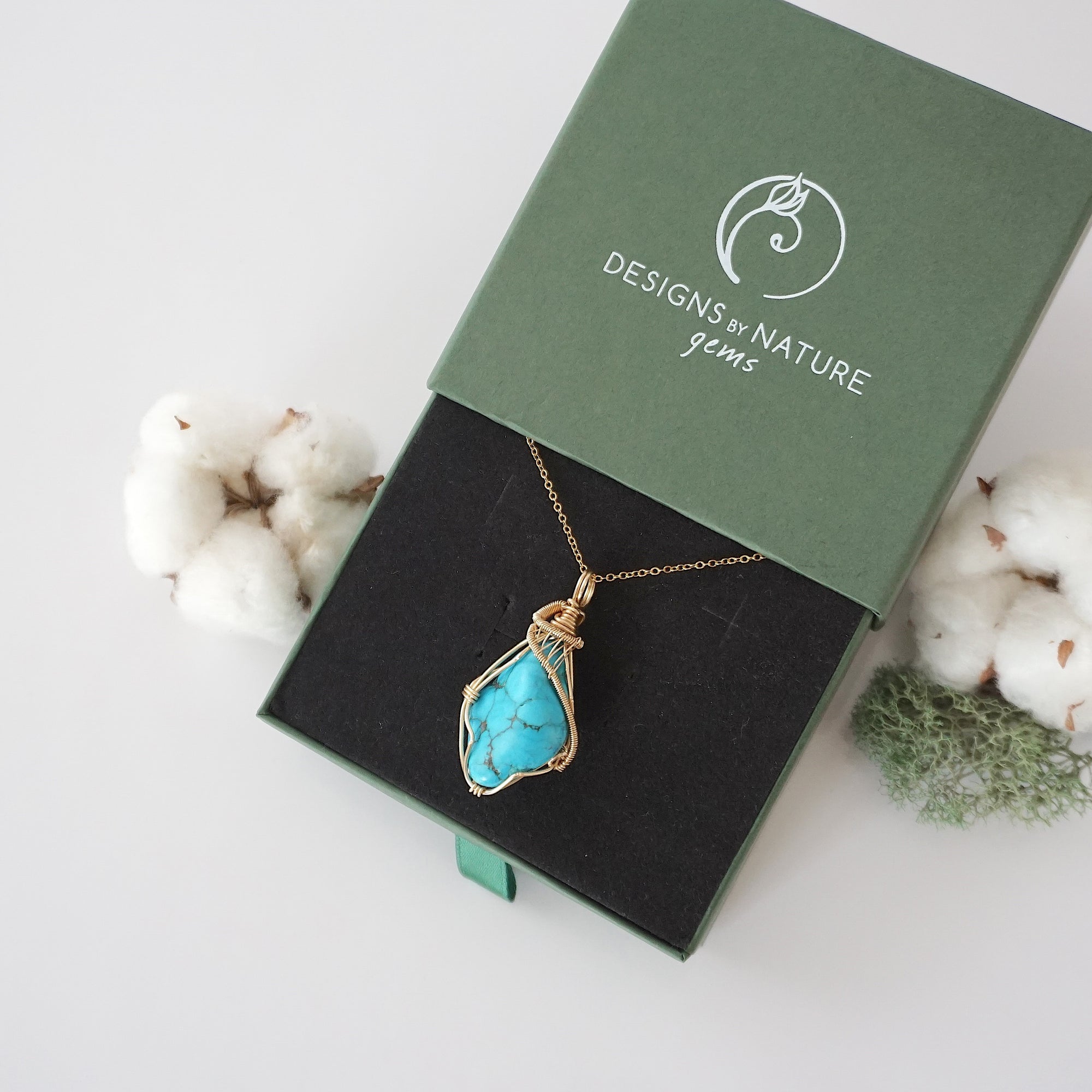 Raw turquoise necklace in 14k gold filled displayed in branded Designs by Nature Gems jewelry box. Artisan December birthstone gift for women.