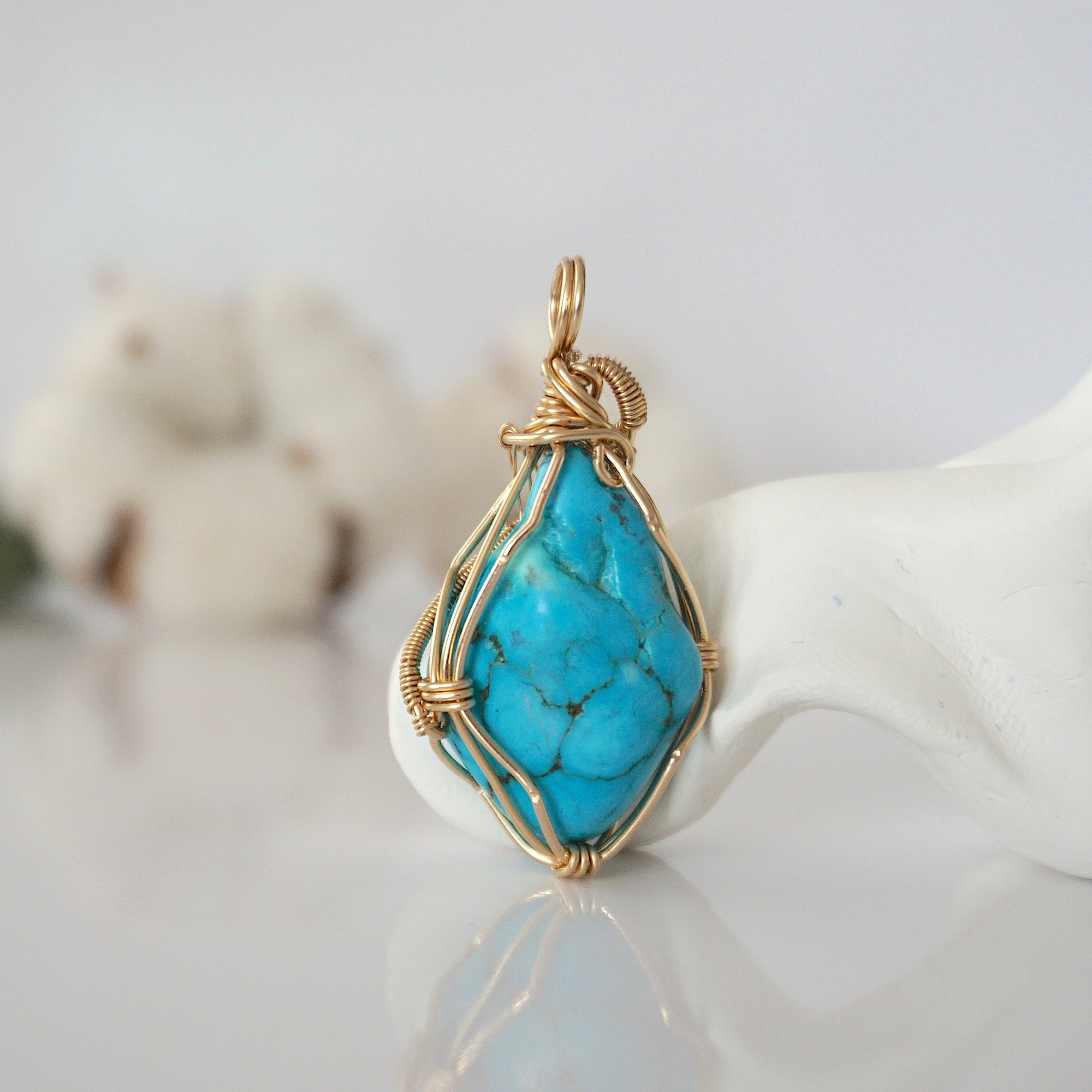 Back view of raw turquoise pendant in 14k gold filled, highlighting stone and wire detail. One of a kind December birthstone jewelry by Designs by Nature Gems.