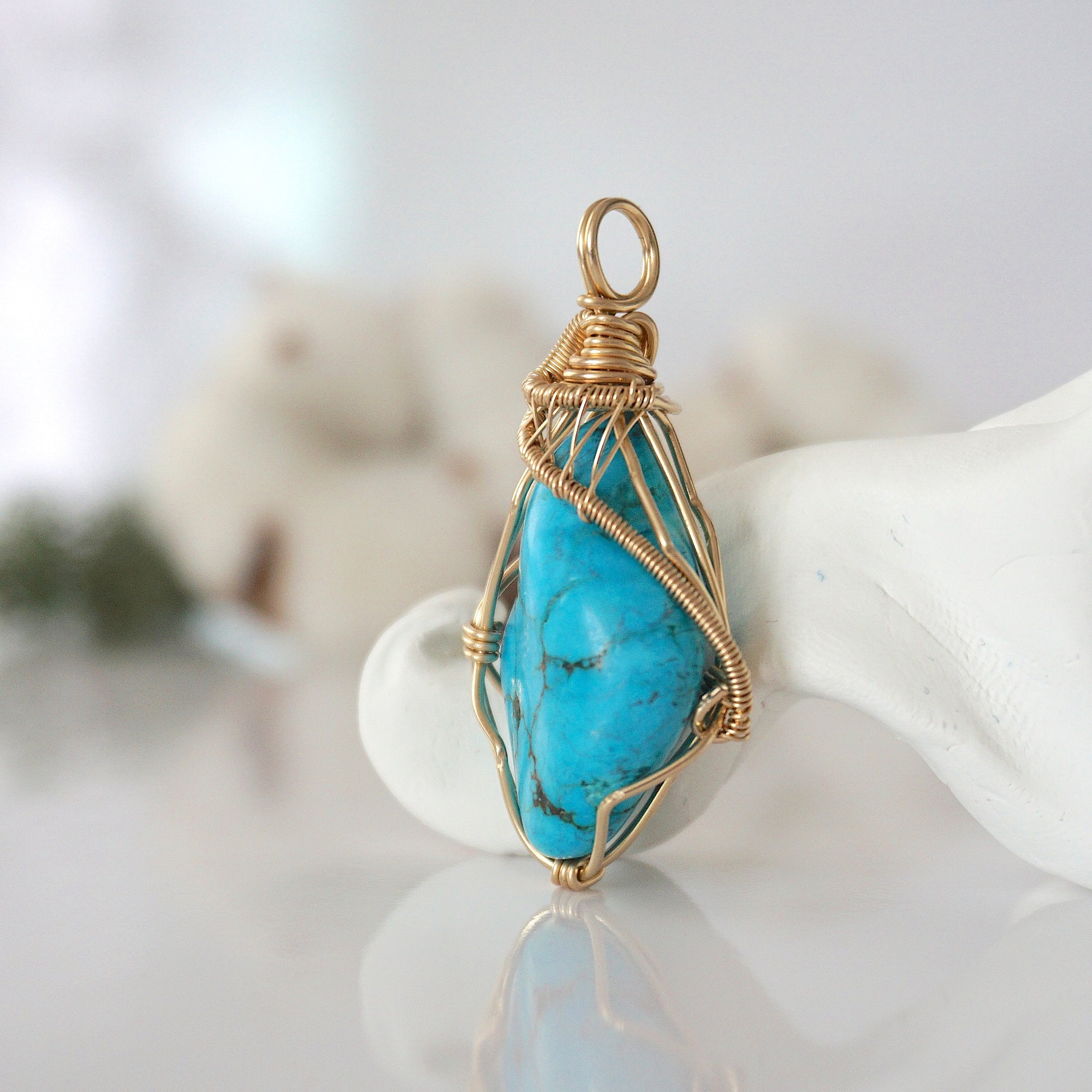Side view of raw turquoise pendant in 14k gold filled, showing artisan wire wrapping. Handcrafted December birthstone necklace by Designs by Nature Gems.