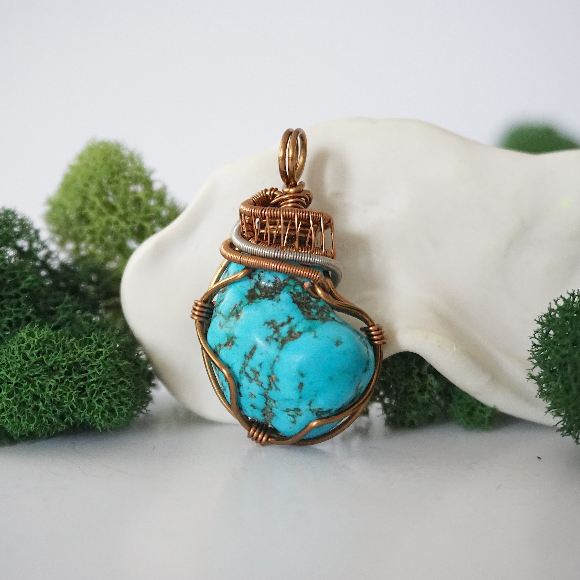Front view of raw turquoise pendant showing detailed antique bronze copper wire wrapping, handmade artisan jewelry
