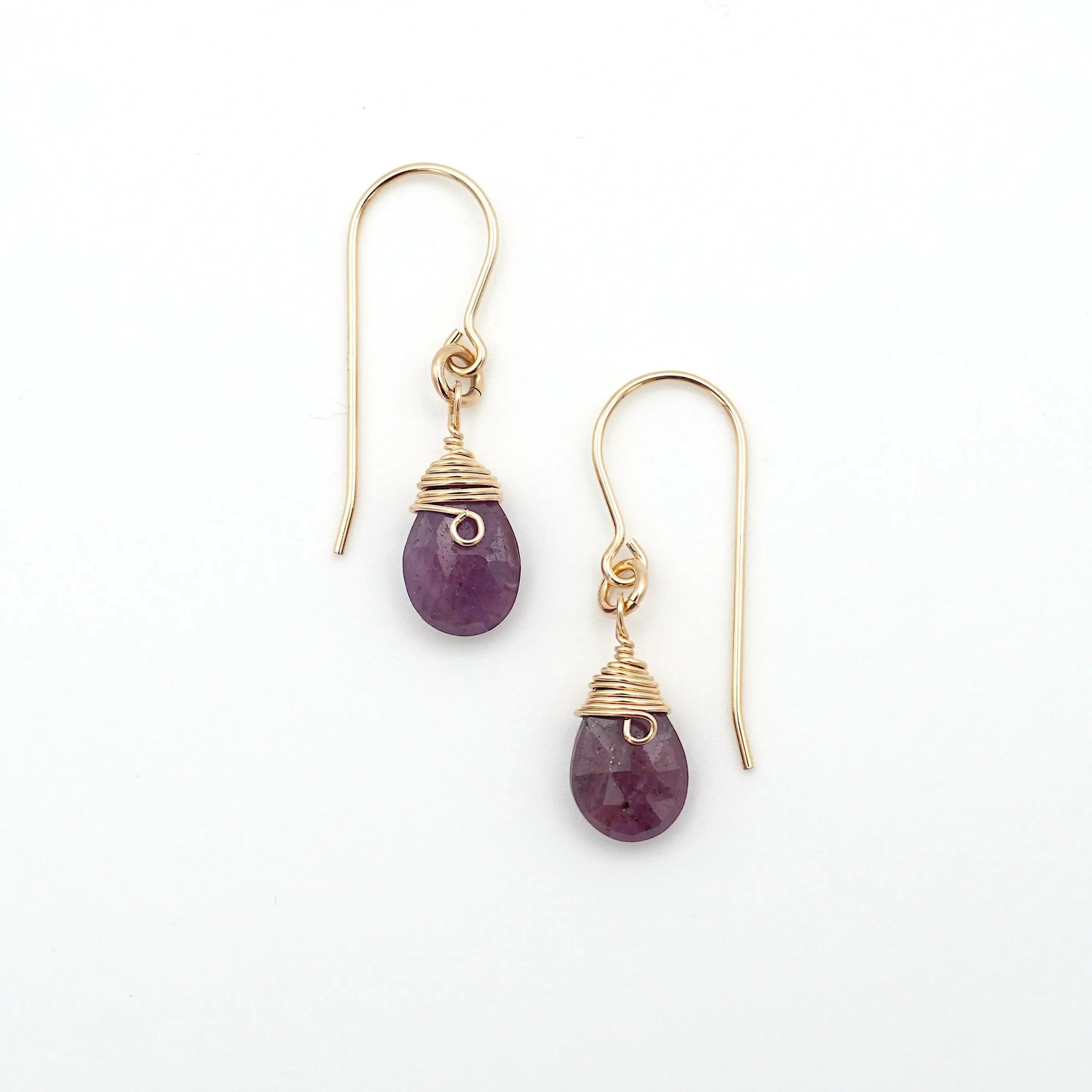 Detailed front view of ruby drop earrings, genuine faceted ruby with minimalist 14k gold filled wire wrapping, Designs by Nature Gems