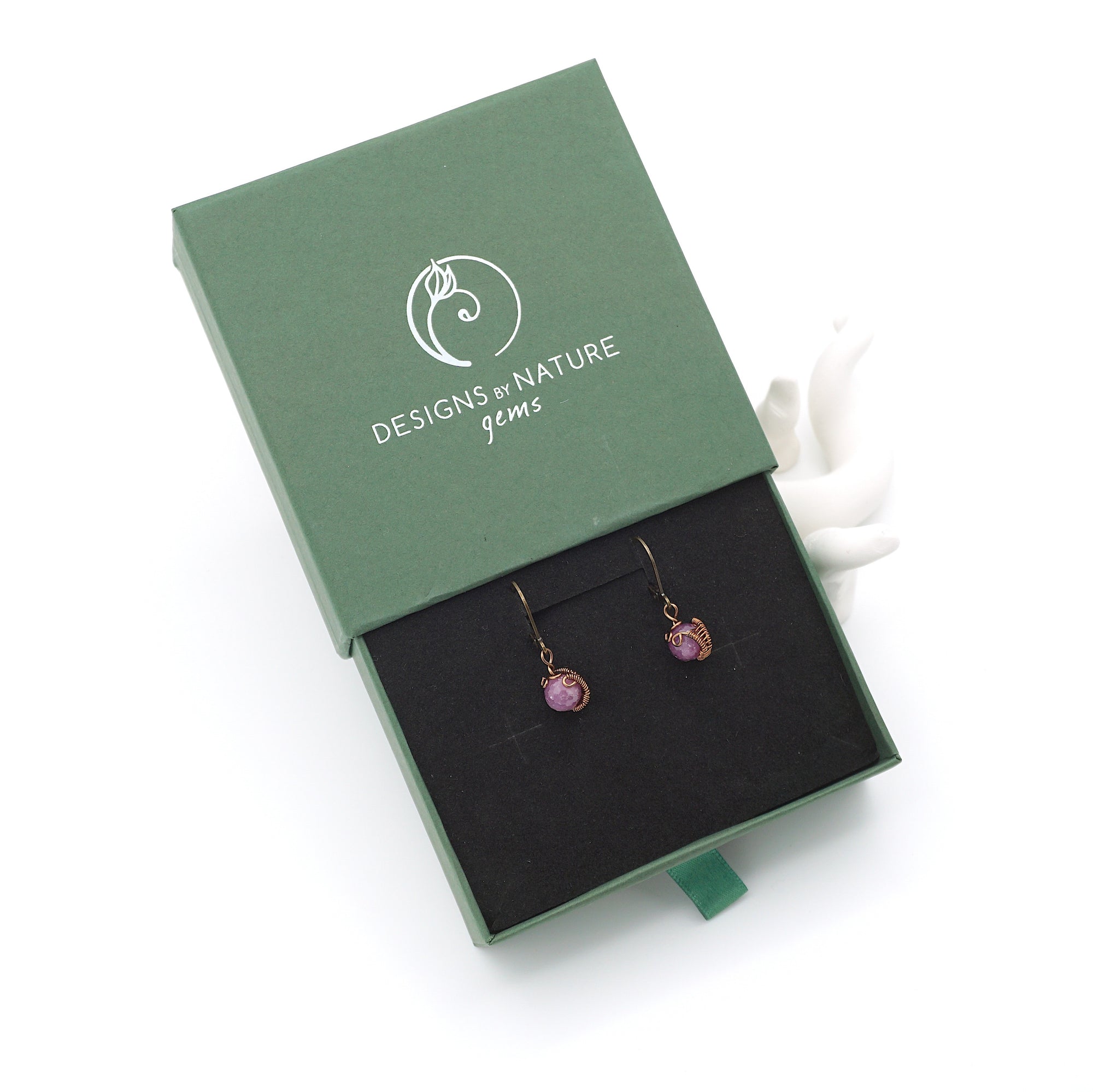 Ruby drop earrings presented in a branded gift box, ready for gifting, with antique bronze copper wire wrapping.