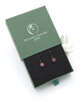 Ruby drop earrings presented in a branded gift box, ready for gifting, with antique bronze copper wire wrapping.