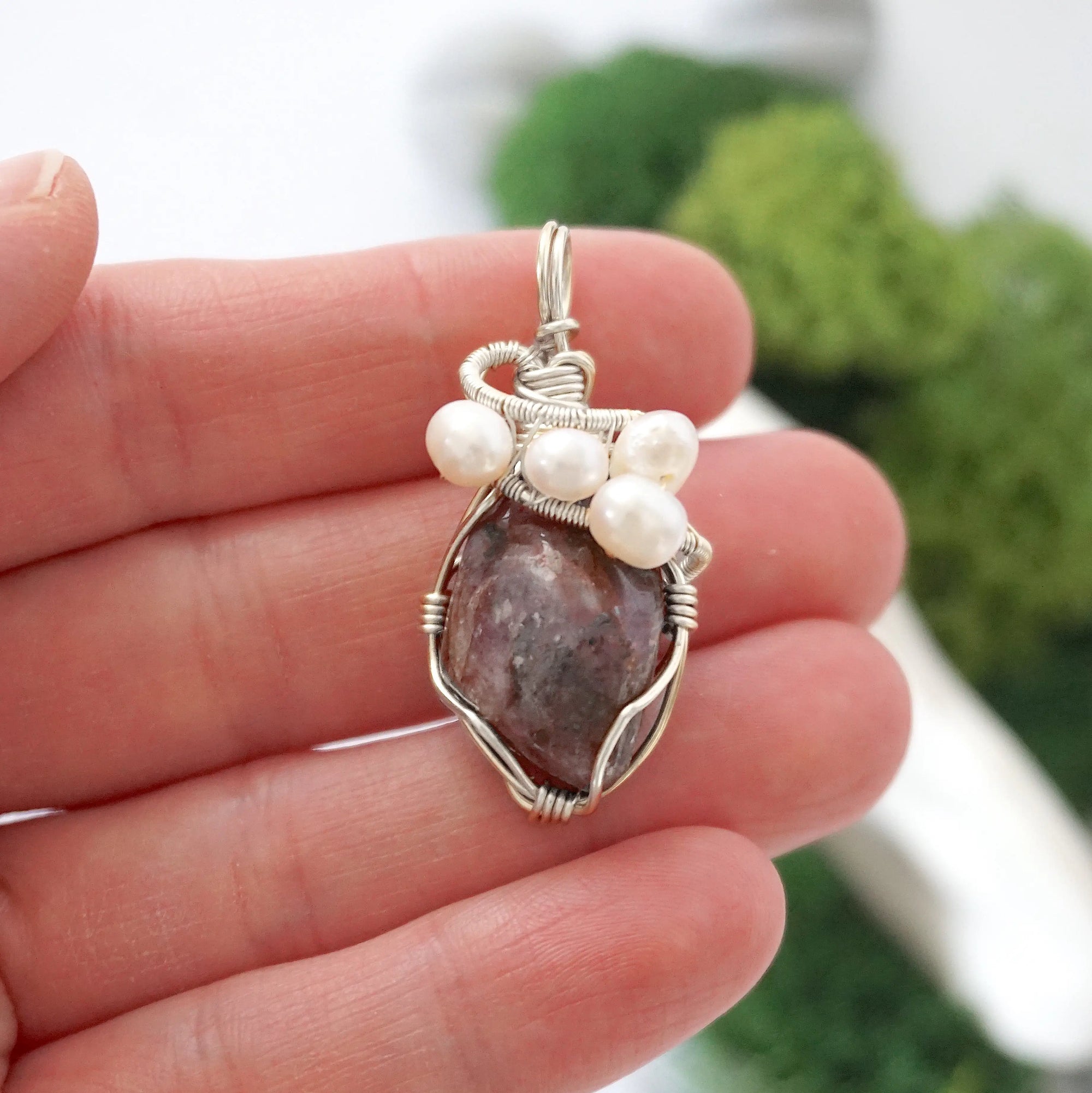 Ruby and freshwater pearl pendant necklace in hand for size reference, silver wire wrapped, handcrafted gemstone jewelry