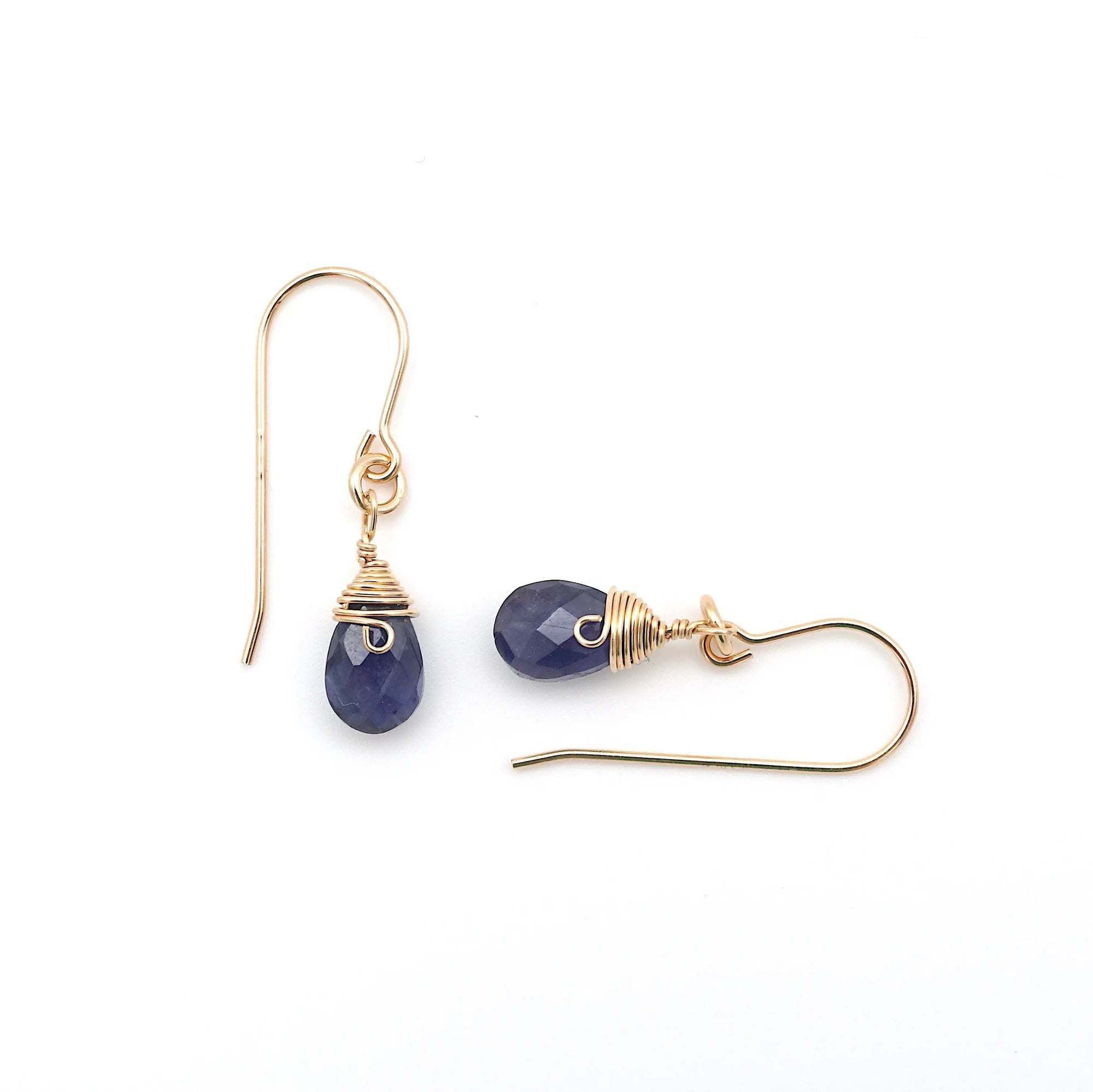 Closeup showing details of sapphire drop earrings, faceted sapphire stone, 14k gold filled setting