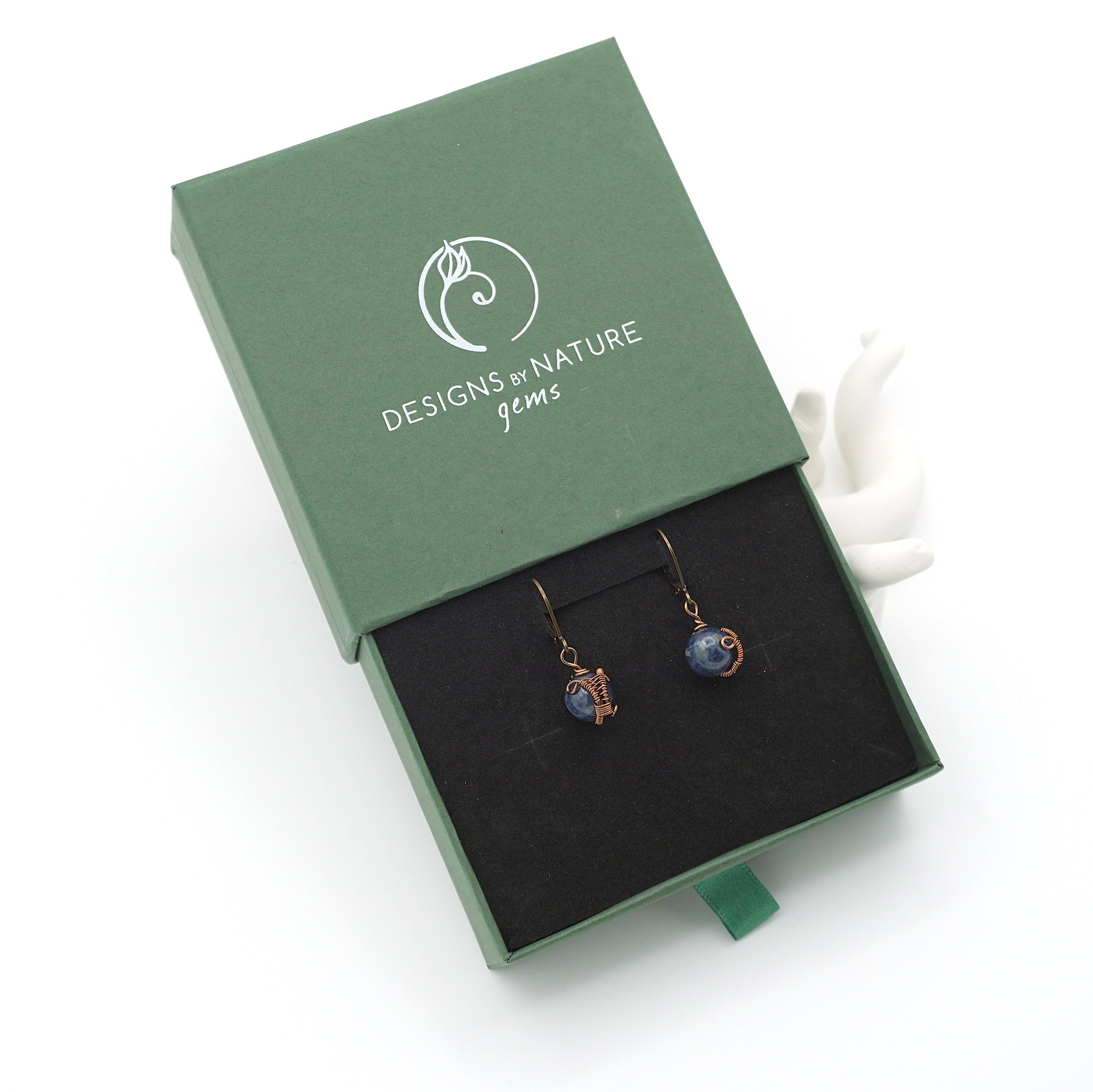 Sapphire drop earrings presented in a branded gift box, ready for gifting, with antique bronze copper wire wrapping.