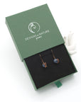 Sapphire drop earrings presented in a branded gift box, ready for gifting, with antique bronze copper wire wrapping.