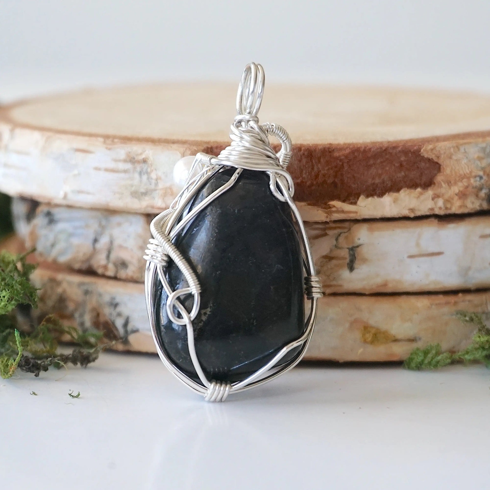 Back detail of silver wire wrapped shungite and freshwater pearl pendant necklace, handcrafted gemstone jewelry