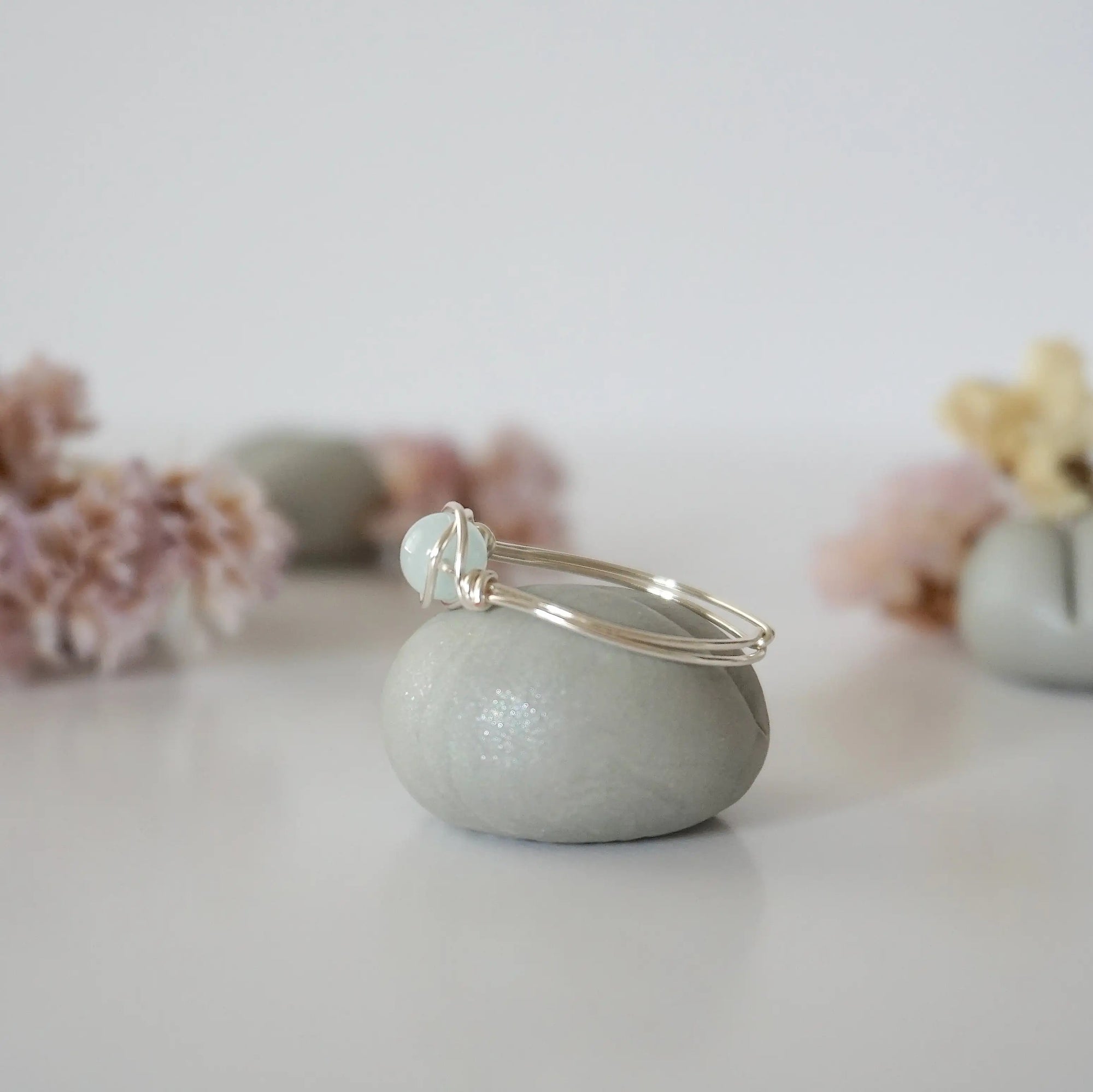 Side angle of silver aquamarine ring, artisan wire wrapped, minimalist design