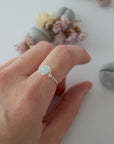 Minimalist silver aquamarine ring on female model's hand, handcrafted, Designs by Nature Gems