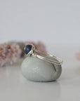 Side-angle detail of silver sapphire ring showing the minimalist wire-wrapped setting and natural 6mm sapphire bead