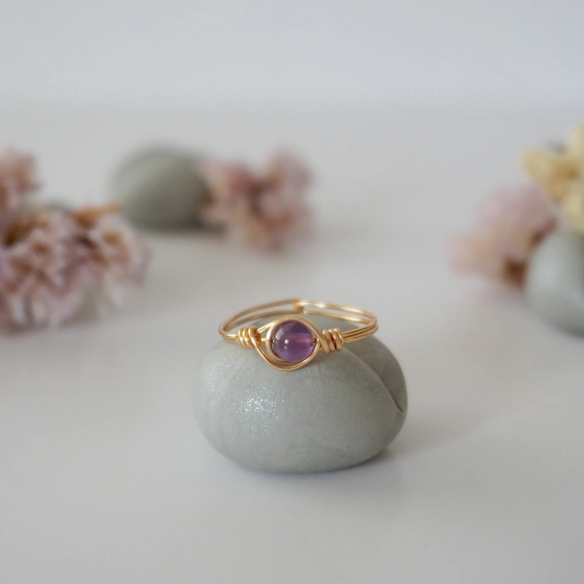 Front view of gold amethyst ring with polished 6mm natural amethyst bead, minimalist wire wrapped band