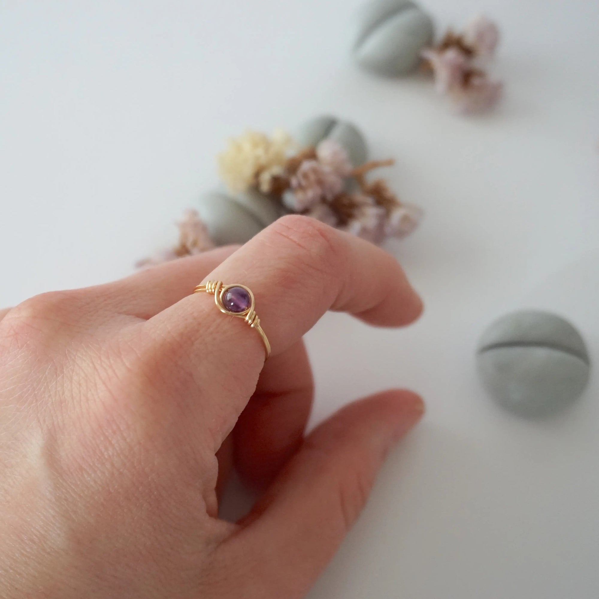 Simple amethyst birthstone ring in gold finish on model hand, minimalist wire wrapped 6mm amethyst bead