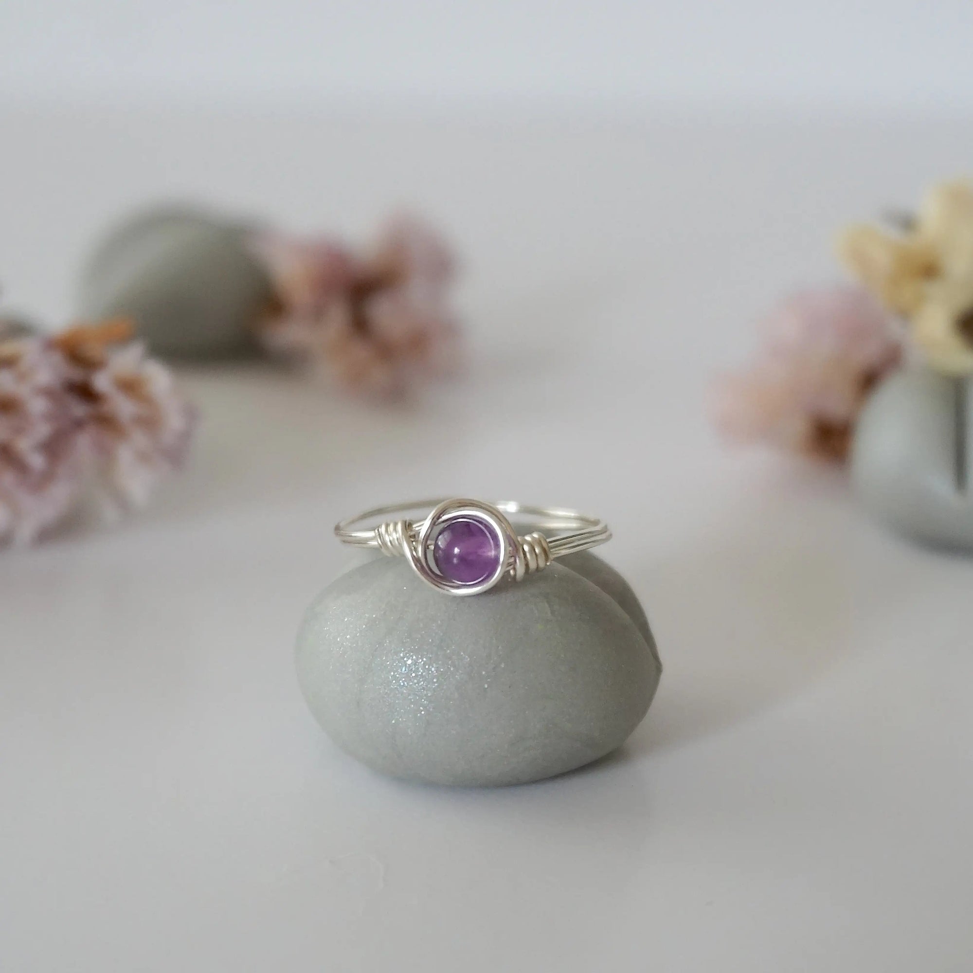 Front view of silver amethyst ring with polished 6mm natural amethyst bead, minimalist wire wrapped band