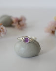 Front view of silver amethyst ring with polished 6mm natural amethyst bead, minimalist wire wrapped band