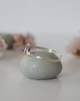 Side view detail of silver amethyst ring, minimalist wire wrap holding polished 6mm natural amethyst bead