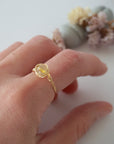 Simple raw citrine ring on woman's hand - minimalist wire wrapped crystal ring in silver showing delicate everyday stacking jewelry for women