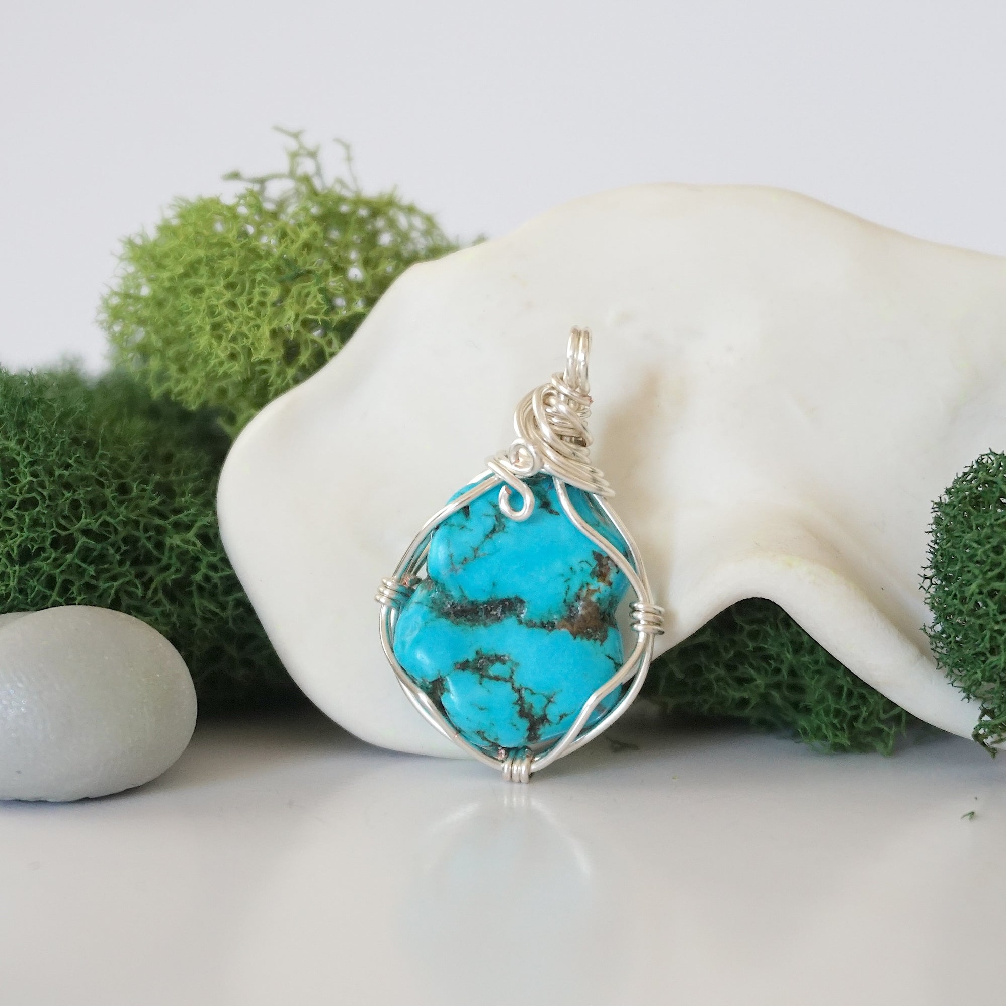 Back view of simple wire wrapped raw turquoise pendant showing clean silver plated copper craftsmanship