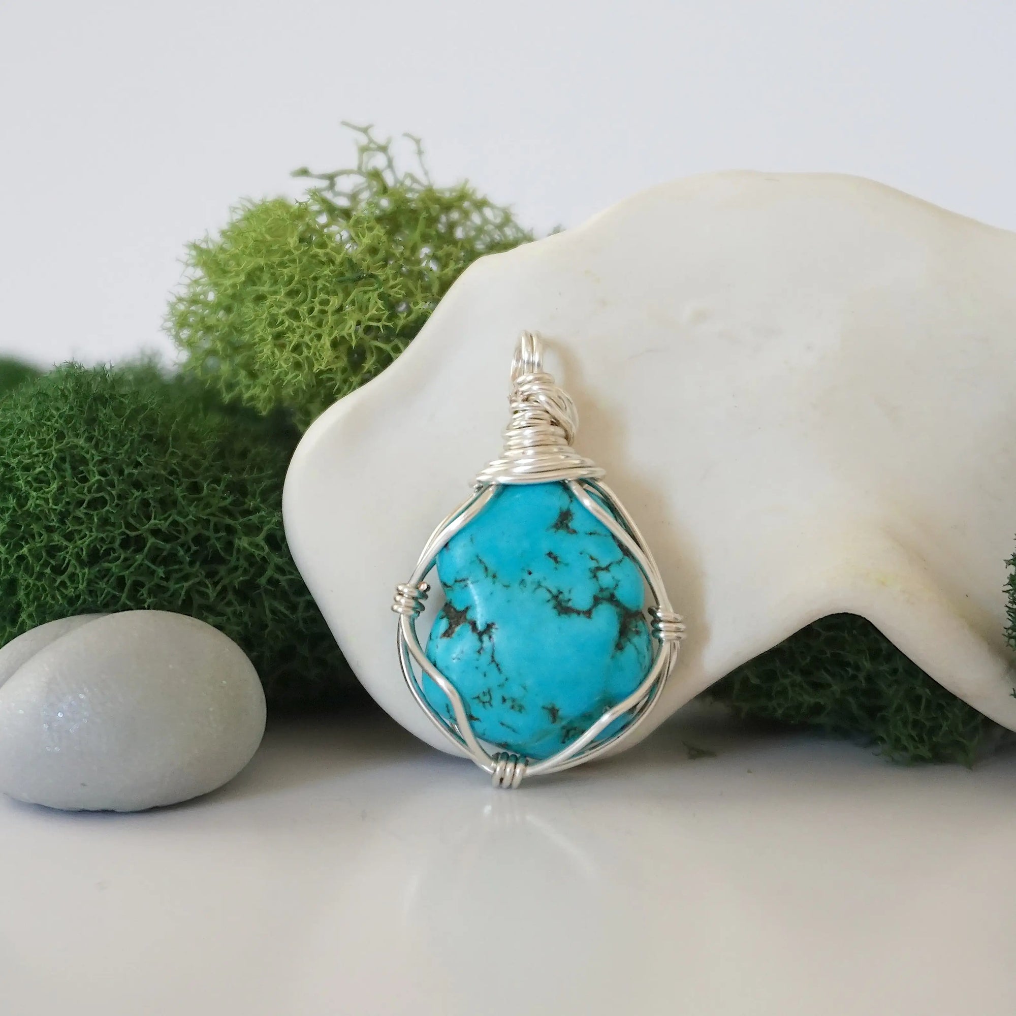 Front view of simple raw turquoise pendant with clean silver wire wrapping, minimalist handmade crystal jewelry