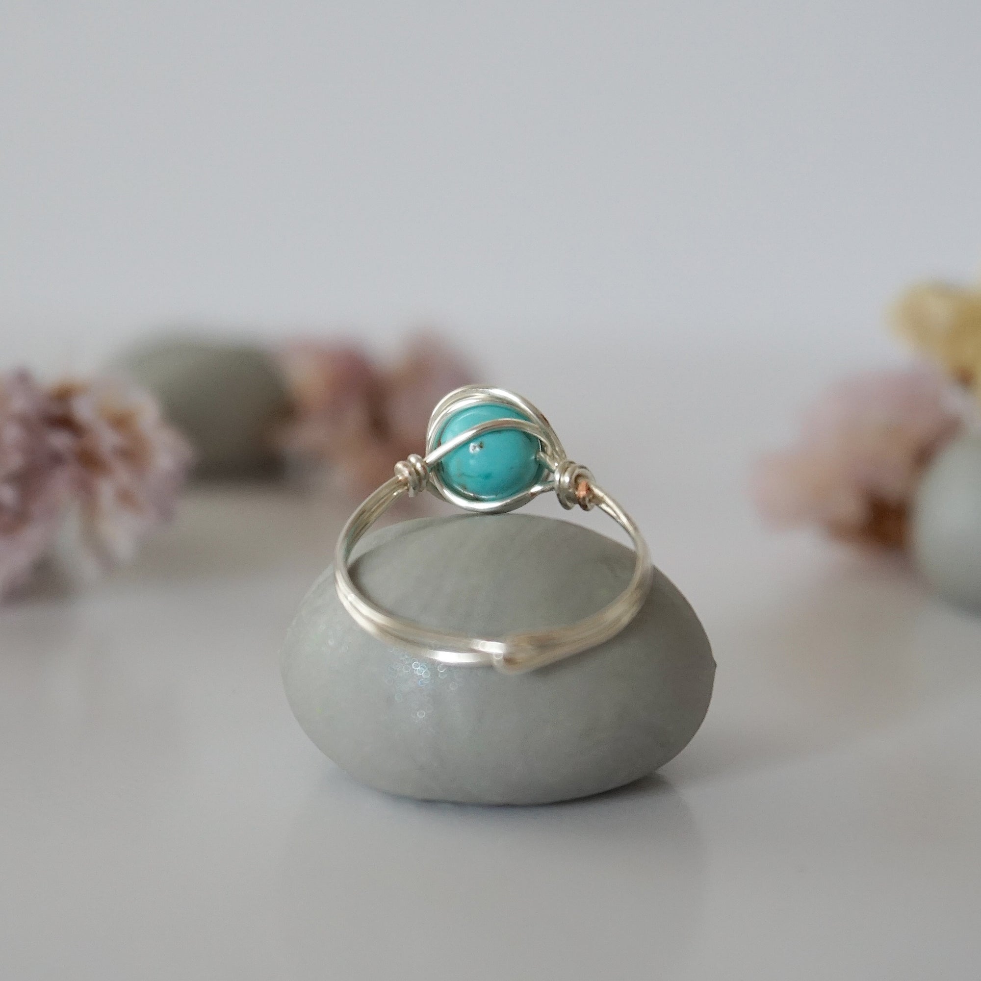 Back view of simple turquoise ring in silver plated copper showing handmade wire wrapping detail and craftsmanship quality