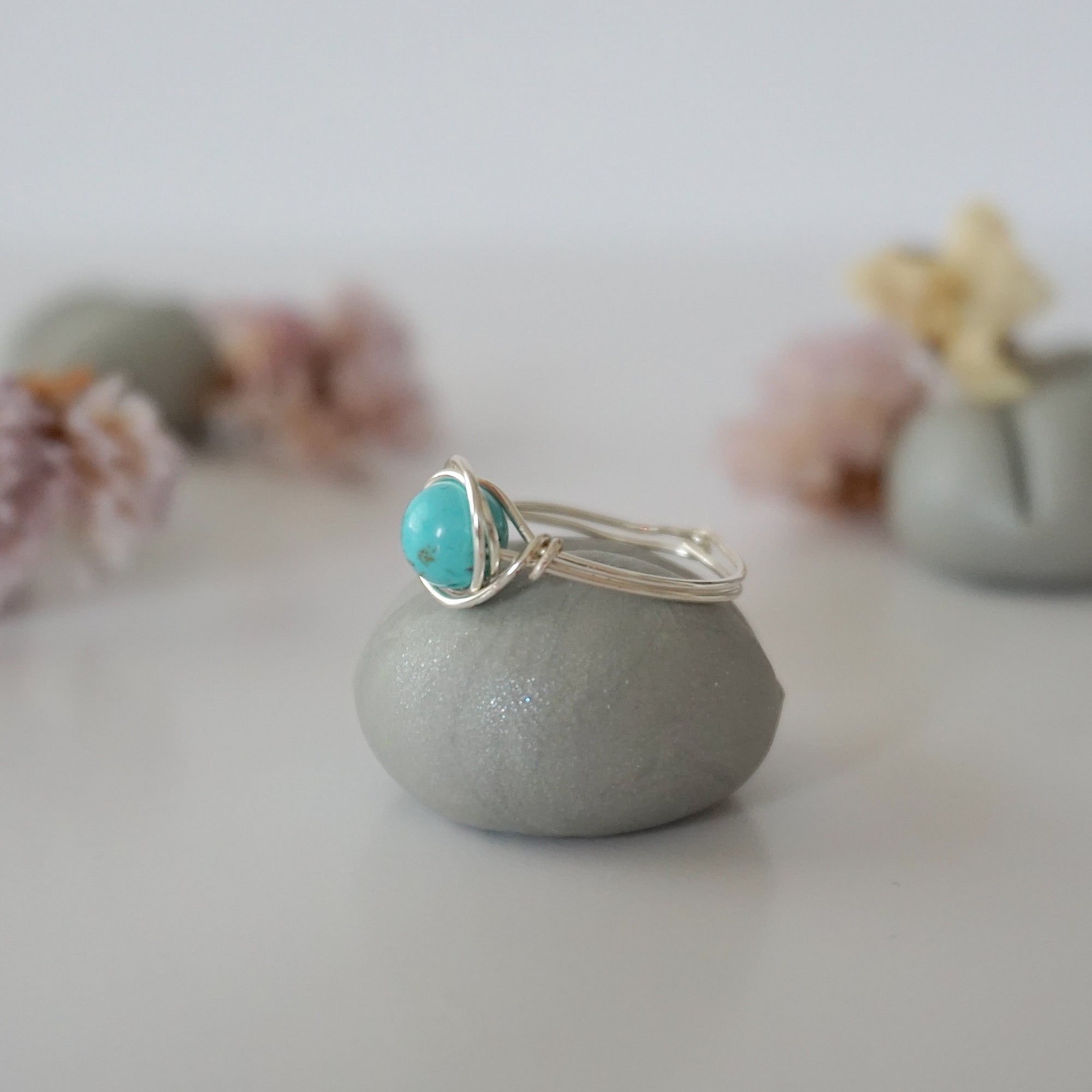 Side profile of simple turquoise ring in silver plated copper showing wire wrap technique and 6mm stone setting detail
