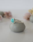 Side profile of simple turquoise ring in silver plated copper showing wire wrap technique and 6mm stone setting detail