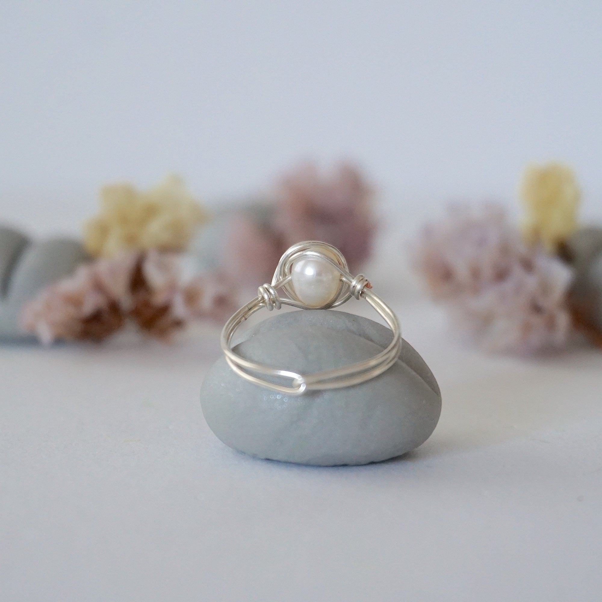 Back view of a minimalist pearl wire wrapped ring crafted in sterling silver