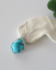 Sterling silver raw turquoise necklace for women with 925 silver chain, handmade wire wrapped crystal pendant flat lay