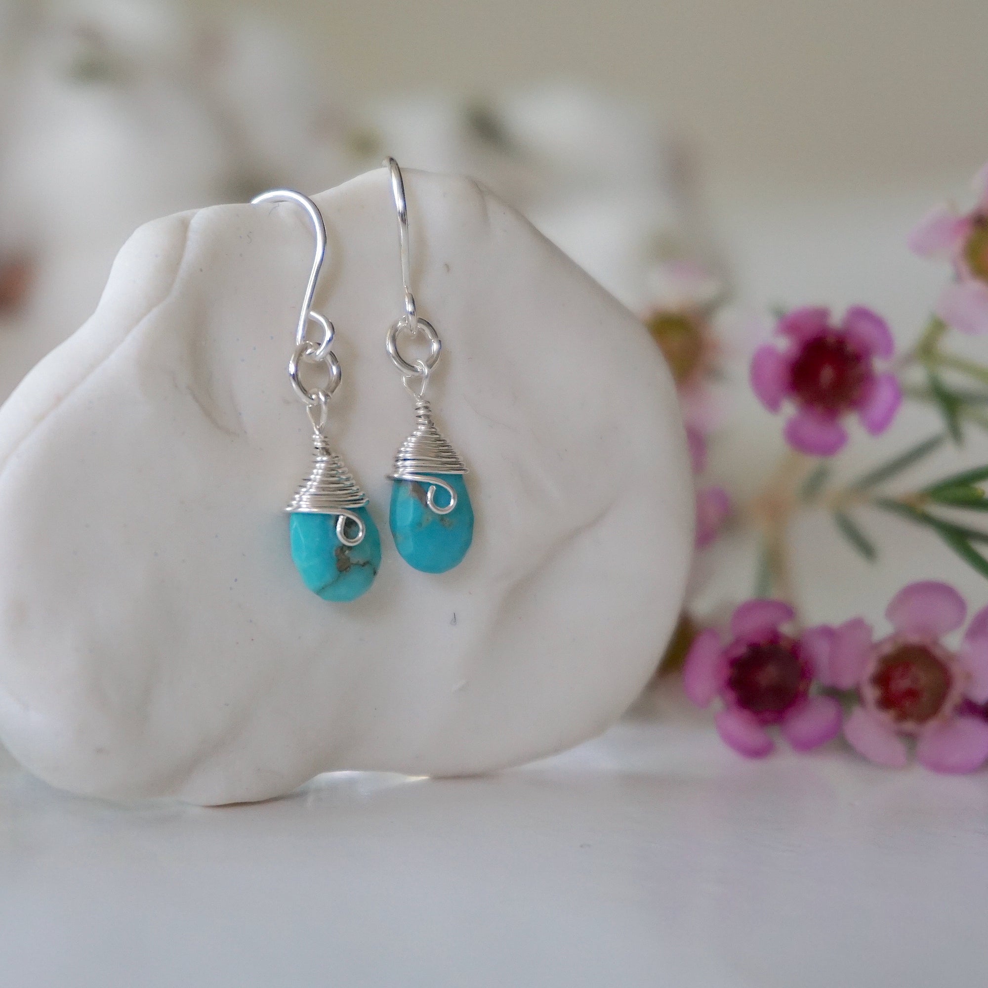 Sterling silver turquoise drop earrings side angle view showing wire wrapped detail 925 silver craftsmanship faceted crystal
