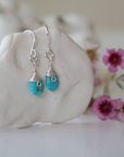 Sterling silver turquoise drop earrings side angle view showing wire wrapped detail 925 silver craftsmanship faceted crystal
