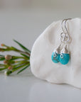 Sterling silver turquoise earrings left side detail natural faceted stone wire wrapped handmade 925 silver hypoallergenic
