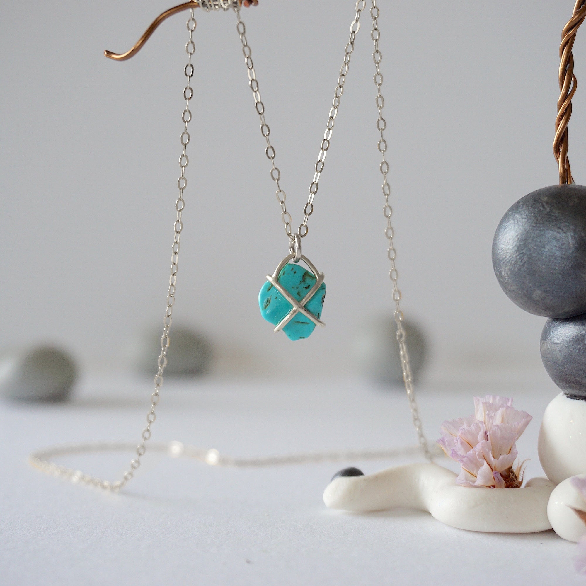 Back view of sterling silver turquoise necklace showing claw prong setting detail