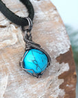 Sterling silver wire wrapped turquoise necklace for men side detail view black leather