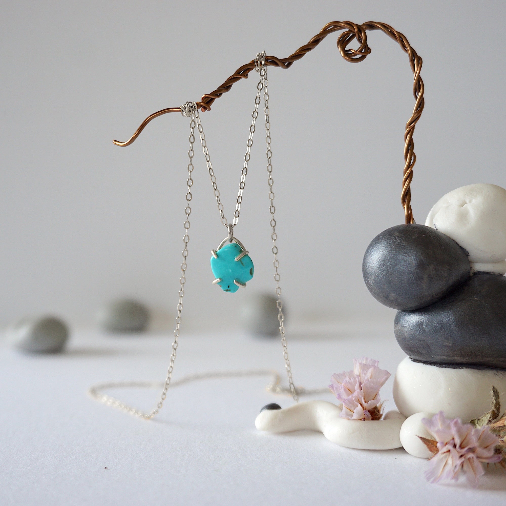 Side angle view of sterling silver turquoise necklace showing stone depth and profile