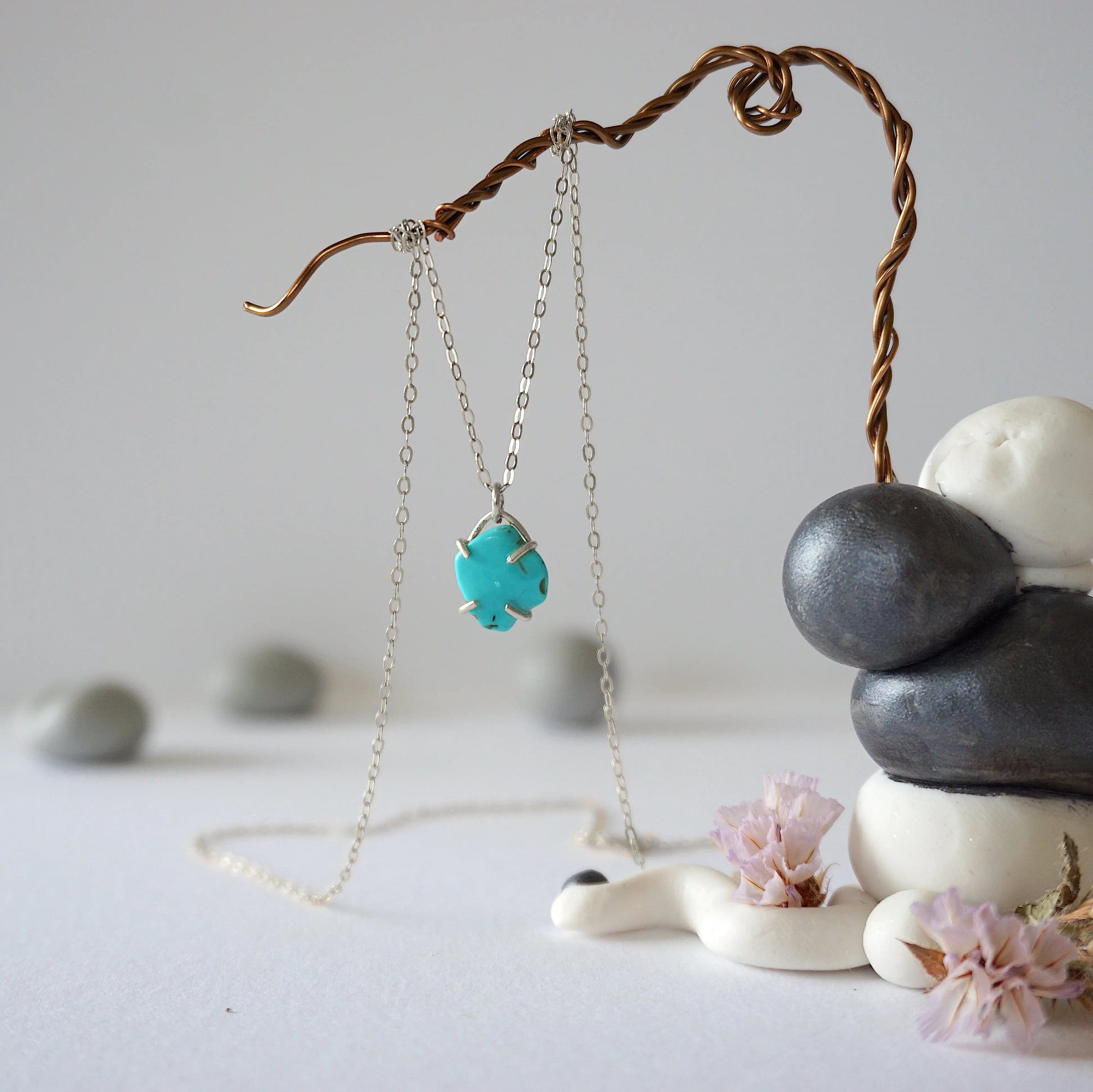 Side angle view of sterling silver turquoise necklace showing stone depth and profile