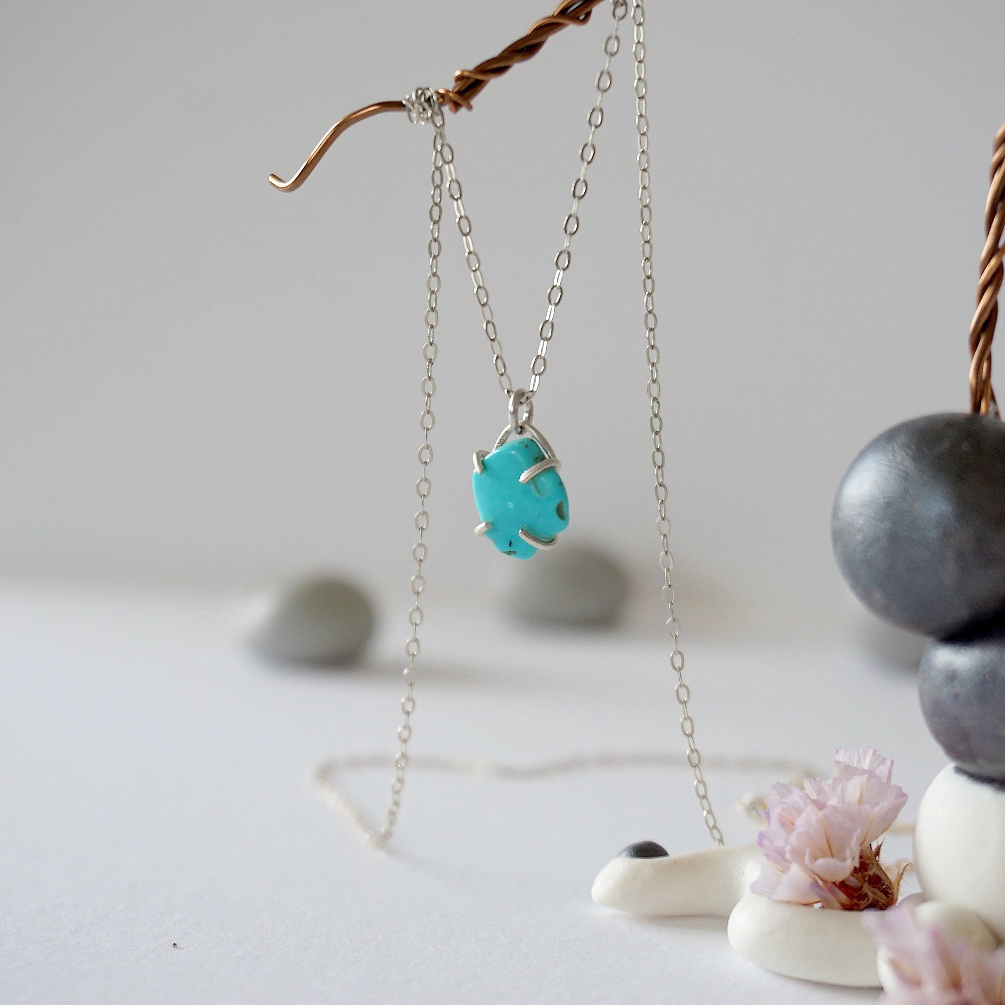 Side angle view of sterling silver turquoise necklace showing stone depth and profile