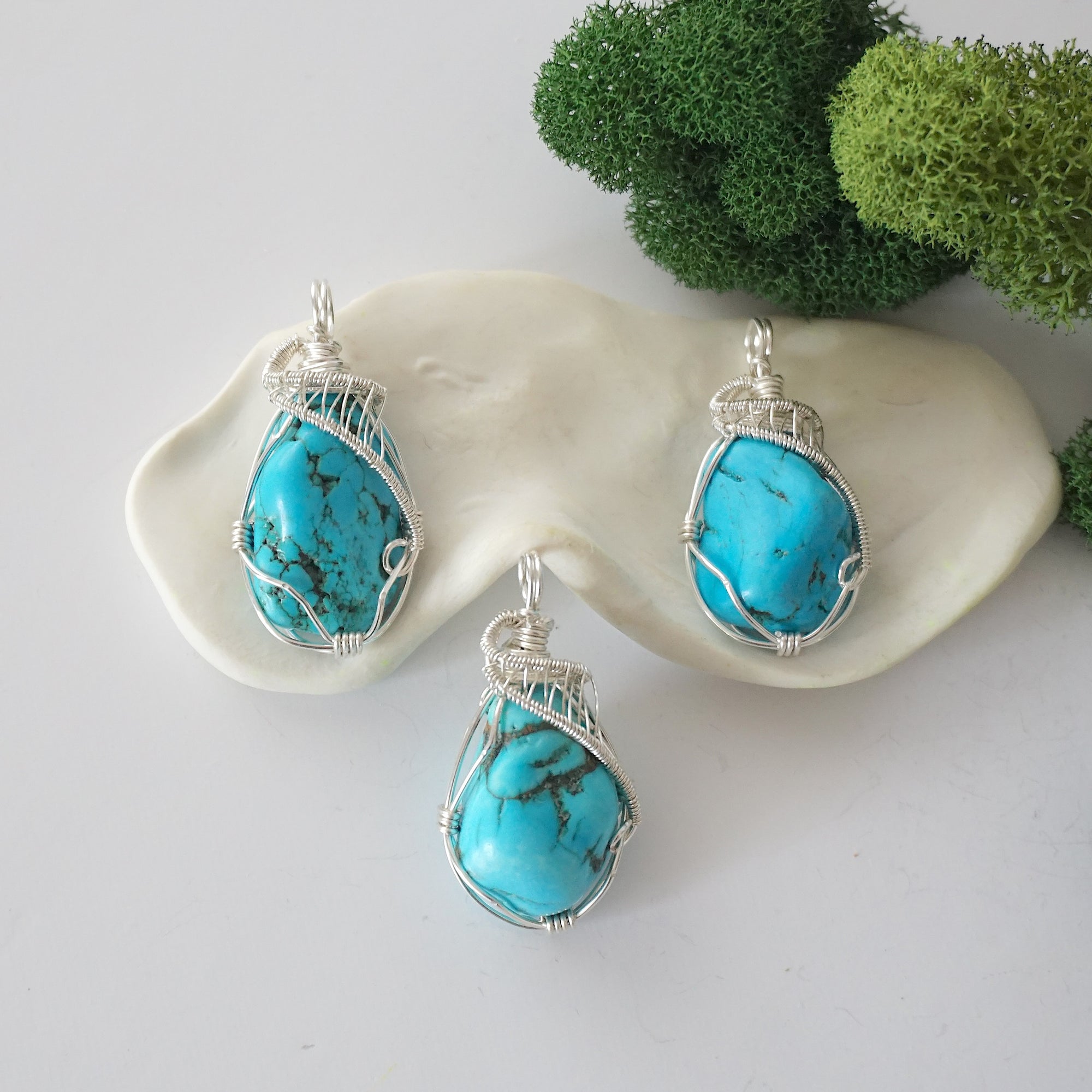 Three sterling silver raw turquoise necklace variations showing natural stone differences, handmade wire wrapped pendants