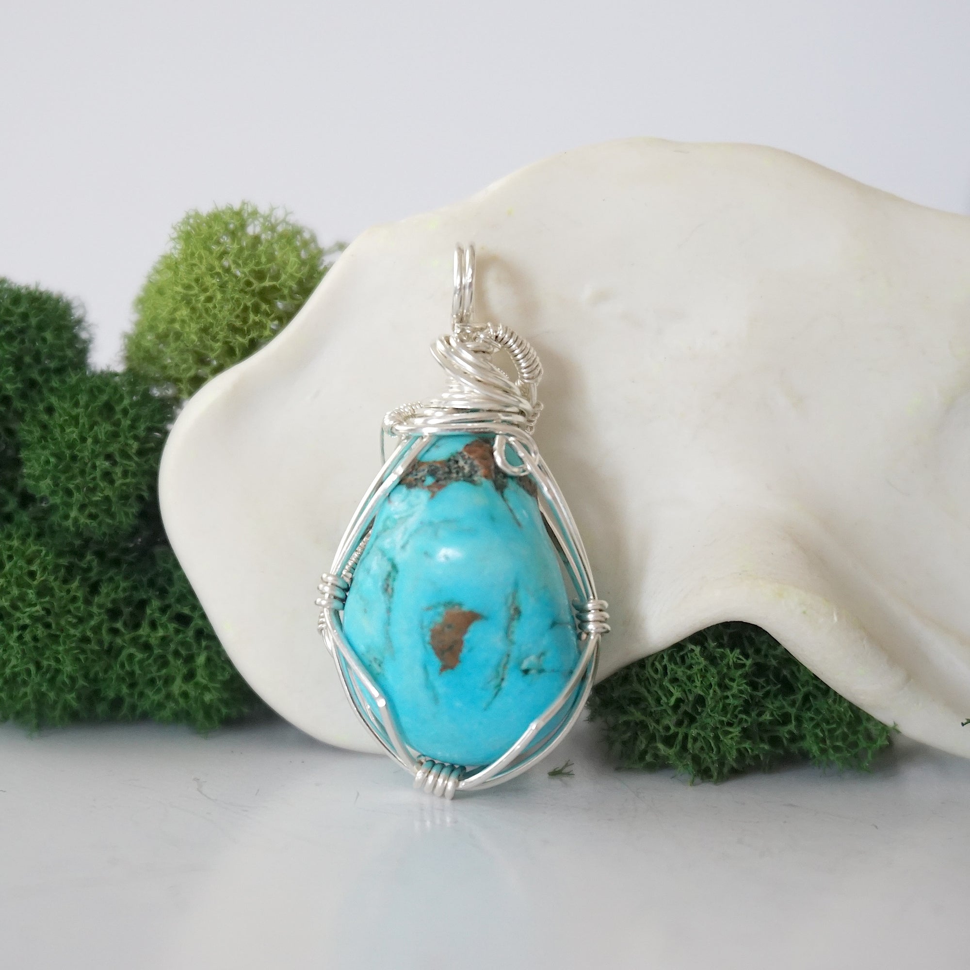 Back view of 925 silver wire wrapped raw turquoise pendant showing detailed craftsmanship and artisan technique