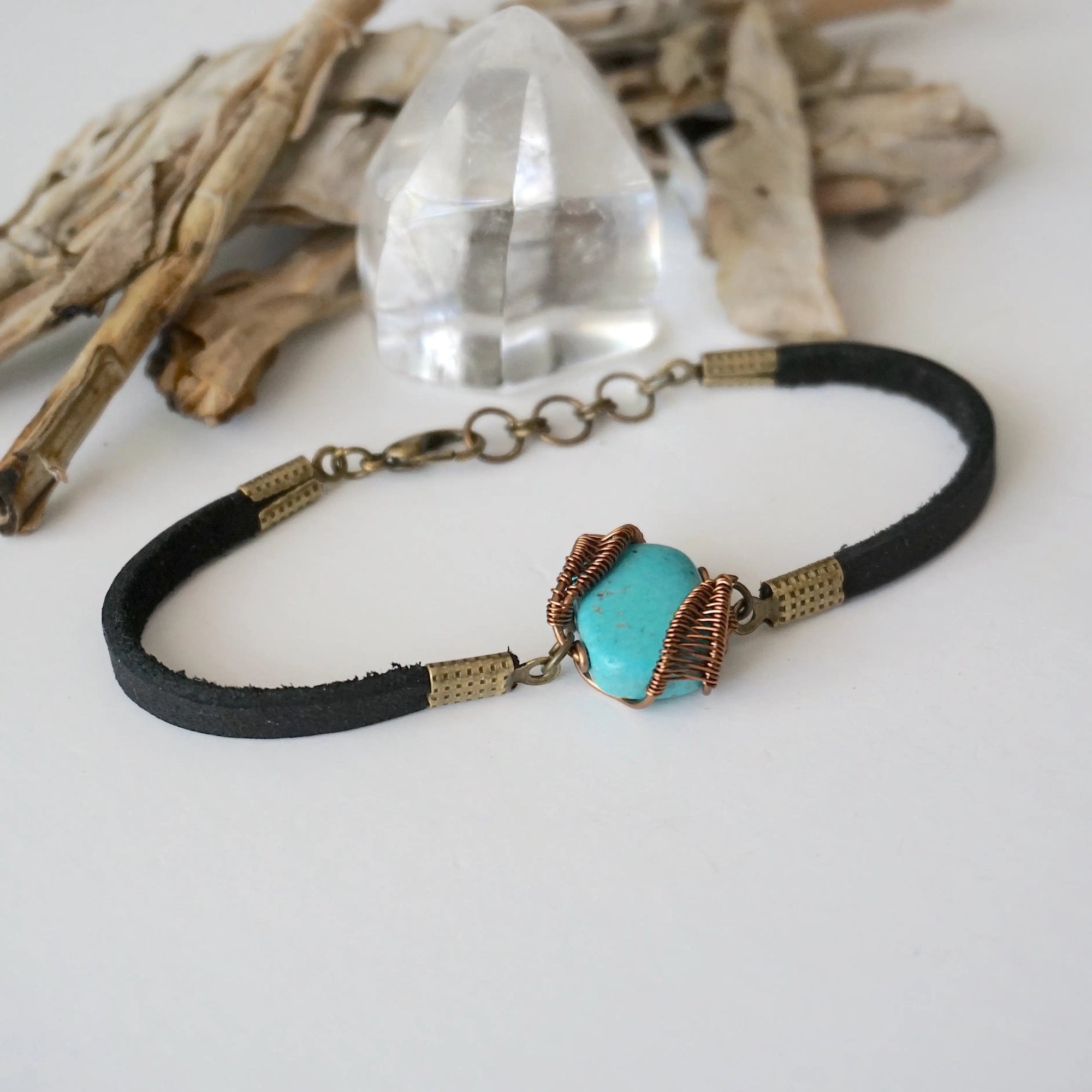 Right side view of natural turquoise stone with detailed antique bronze wire wrapping on leather bracelet, handmade artisan detail

