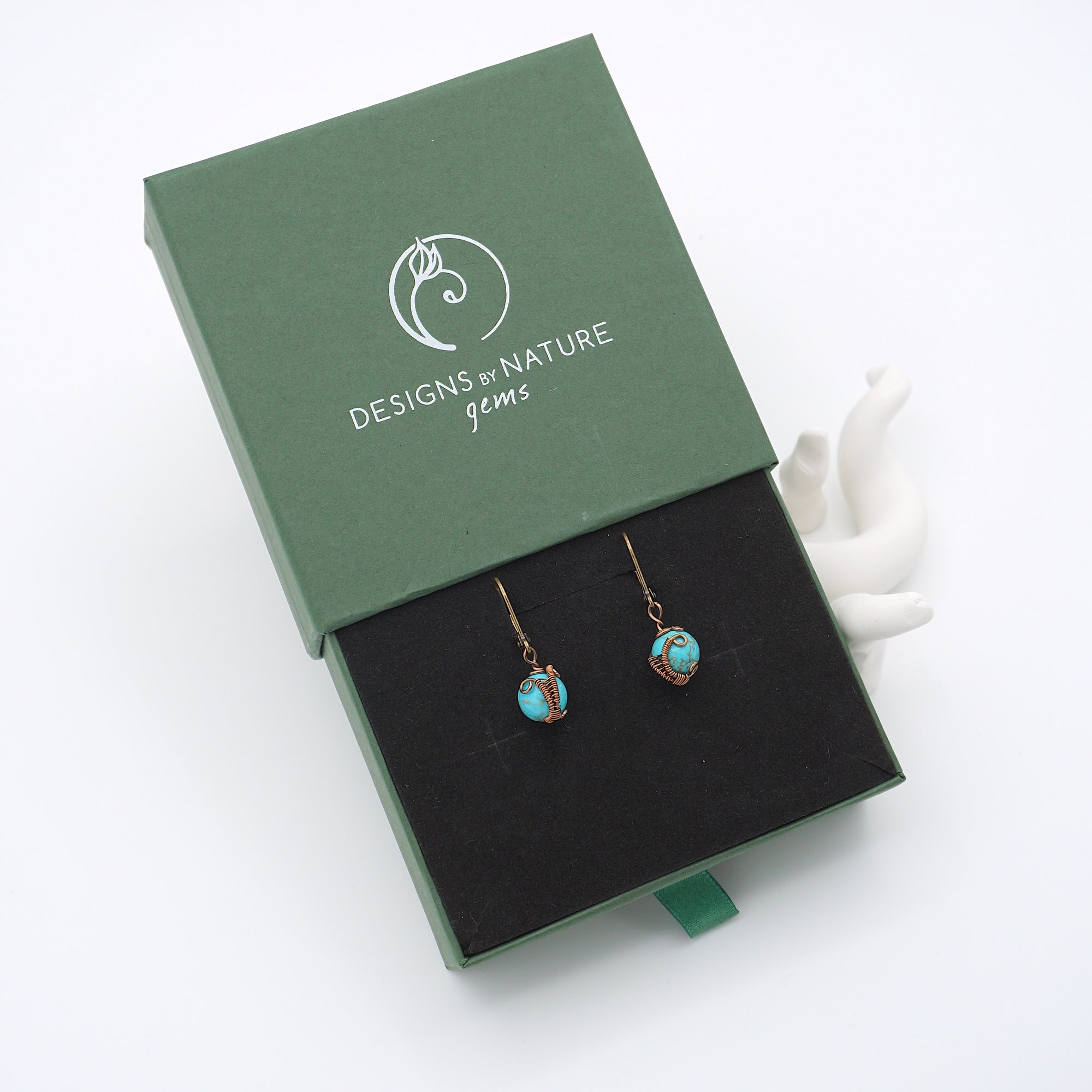 Turquoise drop earrings presented in a branded gift box, ready for gifting, with antique bronze copper wire wrapping.
