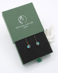 Turquoise drop earrings presented in a branded gift box, ready for gifting, with antique bronze copper wire wrapping.