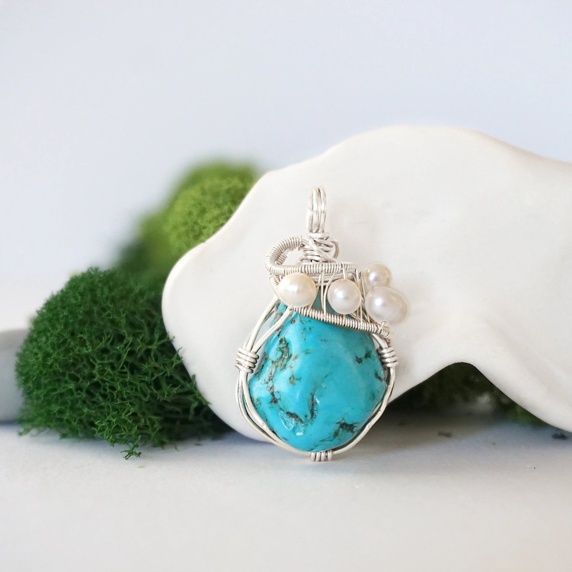 Detailed front view of silver wire wrapped turquoise and freshwater pearl pendant, unique artisan necklace