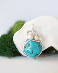 Detailed front view of silver wire wrapped turquoise and freshwater pearl pendant, unique artisan necklace